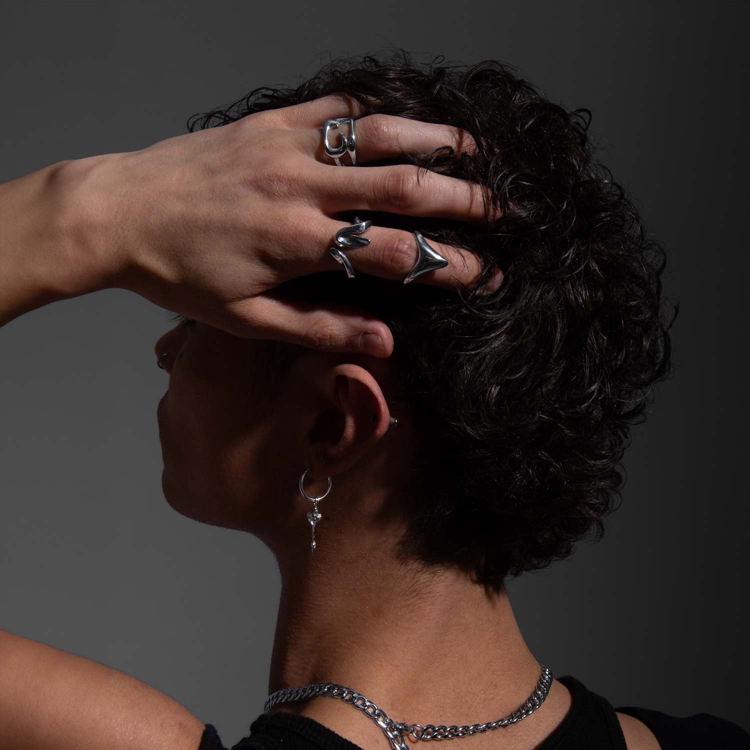 CENTERED SOUL RING worn on a man's hand combined with other jewelry pieces