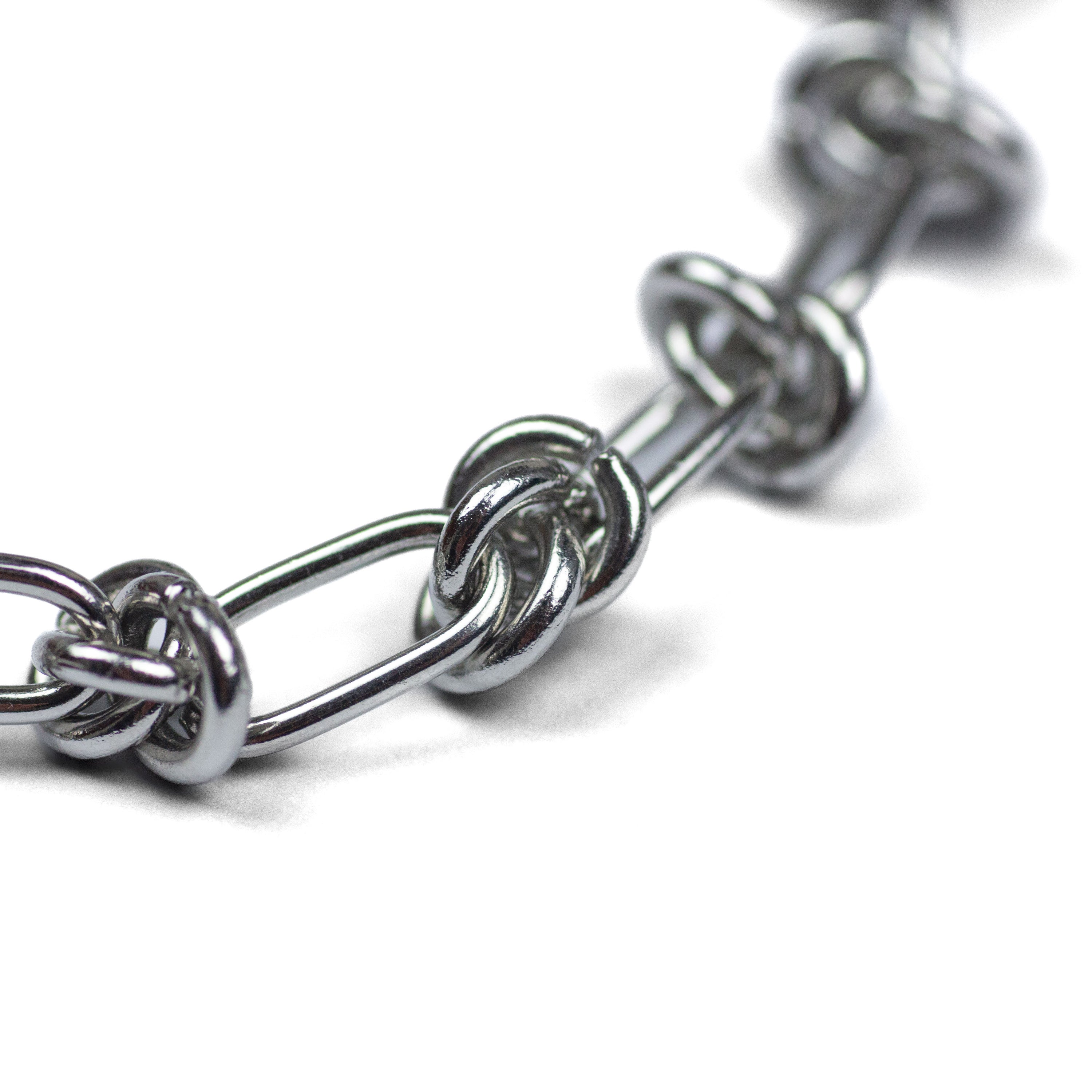 WIRE WEAVE BRACELET made of stainless steel lying close-up on a white background