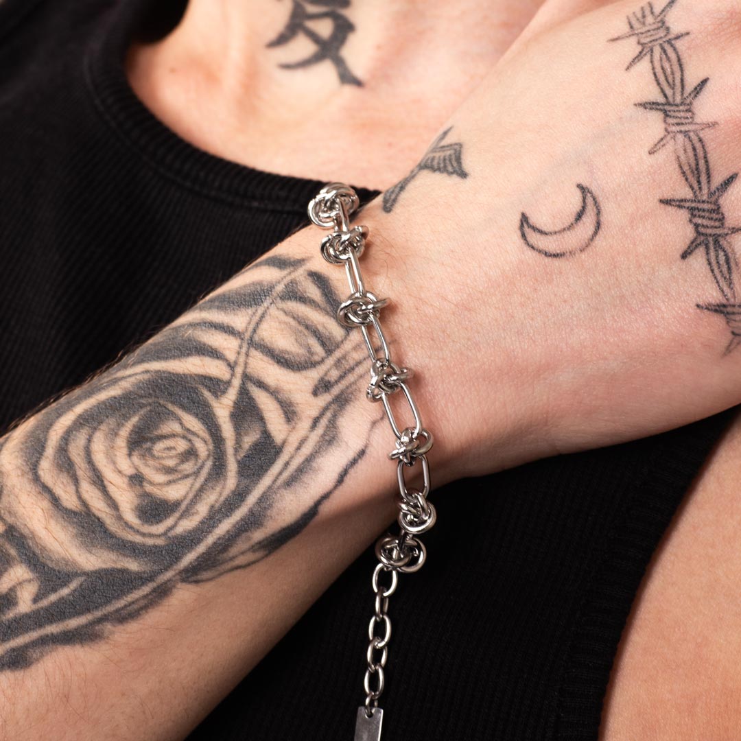 WIRE WEAVE BRACELET made of stainless steel worn close-up in a man's hand close-up